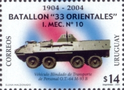 Sobre el escudo del ejército difuminado, la foto de un vehículo blindado de transporte de personal.